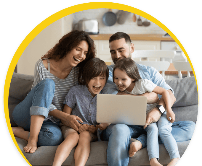 happy family sitting in the sofa with laptop