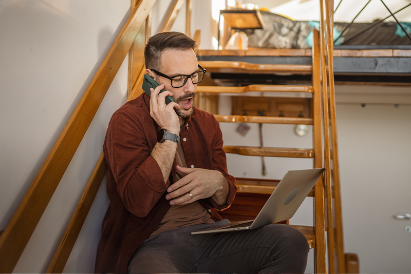 Should You Switch Internet Providers? Pros and Cons Explained 2 Adult man sit and talk on mobile phone with laptop